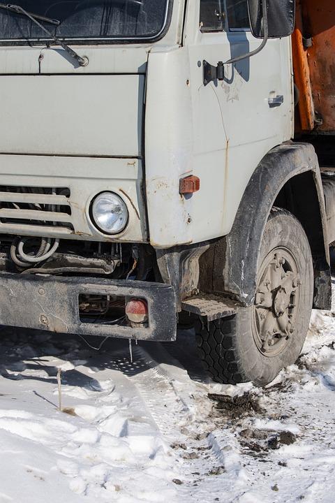 hgv truck in snow with headlights